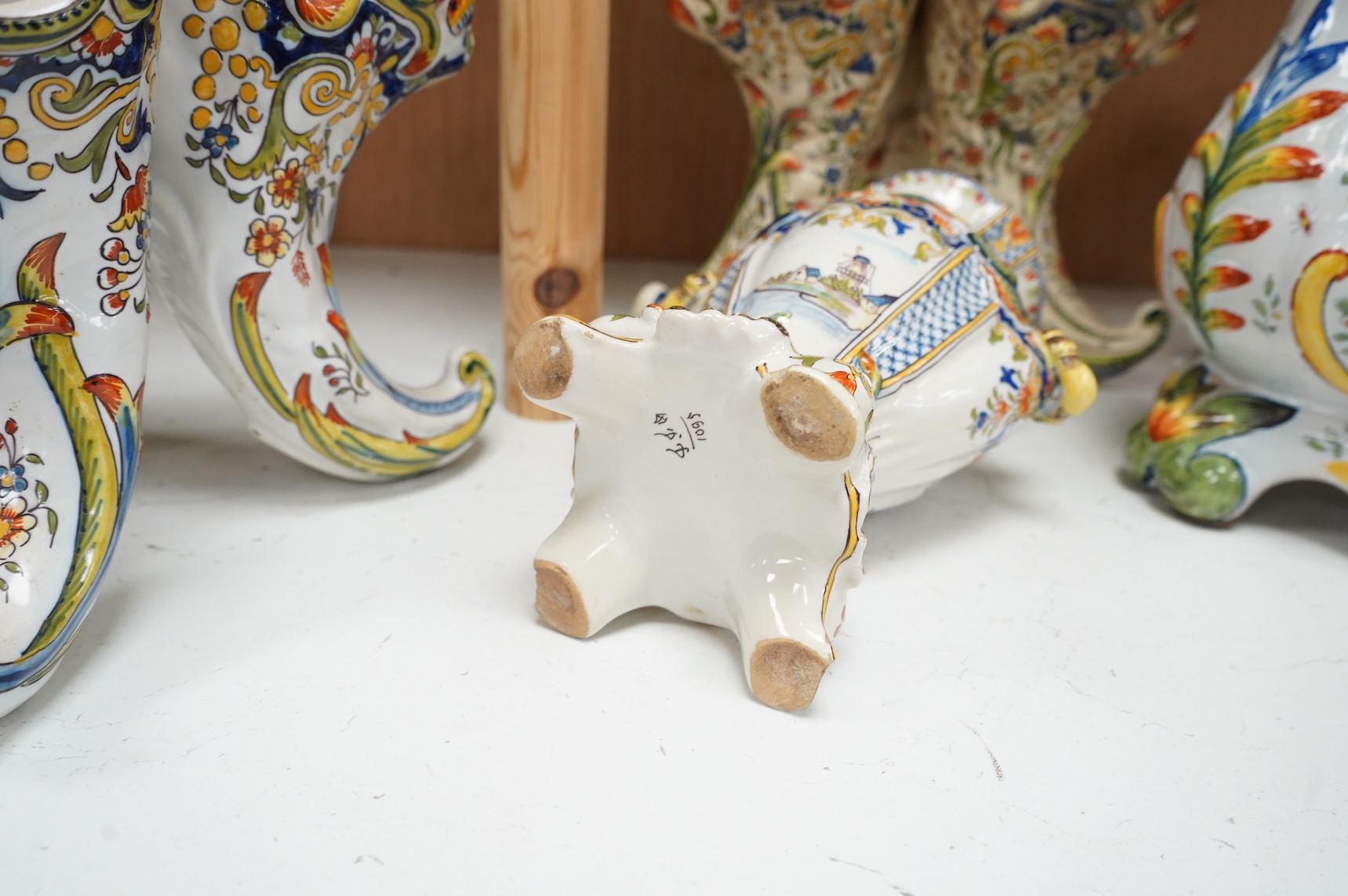 Two late 19th / early 29th century French faience vases and two similar centrepieces, largest 35cm high